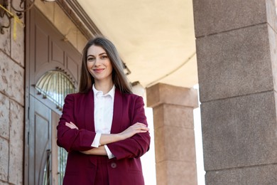 Portrait of young woman wearing stylish suit outdoors