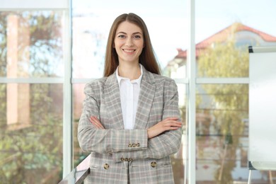 Photo of Portrait of young woman wearing stylish suit indoors