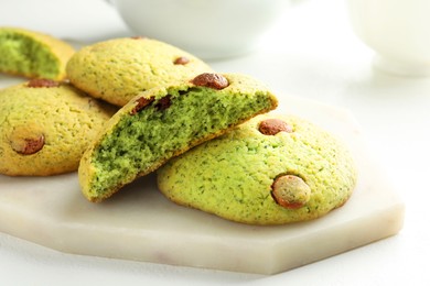 Photo of Delicious mint chocolate chip cookies on white table, closeup