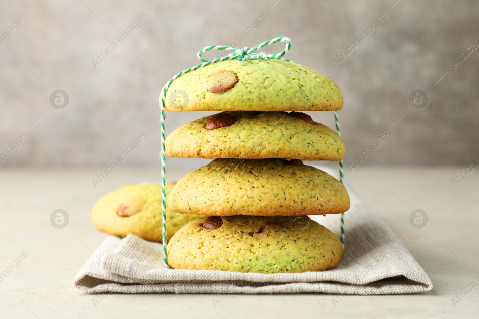 Photo of Delicious mint chocolate chip cookies on light table, closeup