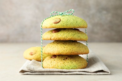 Photo of Delicious mint chocolate chip cookies on light table, closeup