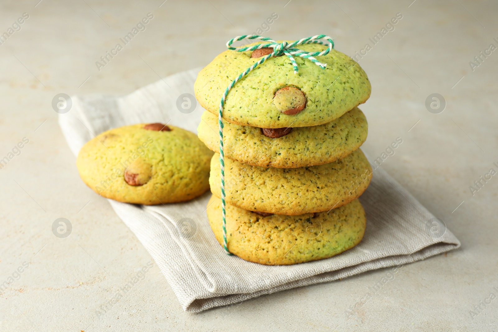 Photo of Delicious mint chocolate chip cookies on light table, closeup