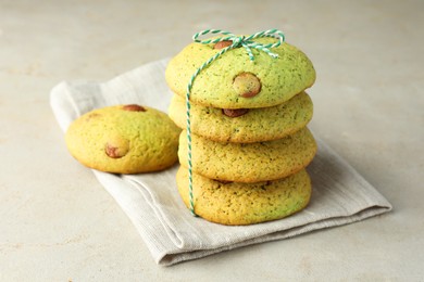 Photo of Delicious mint chocolate chip cookies on light table, closeup