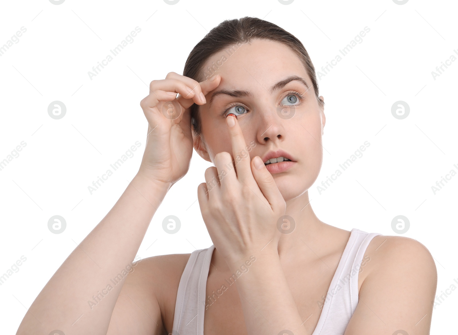 Photo of Young woman putting in red color contact lens on white background