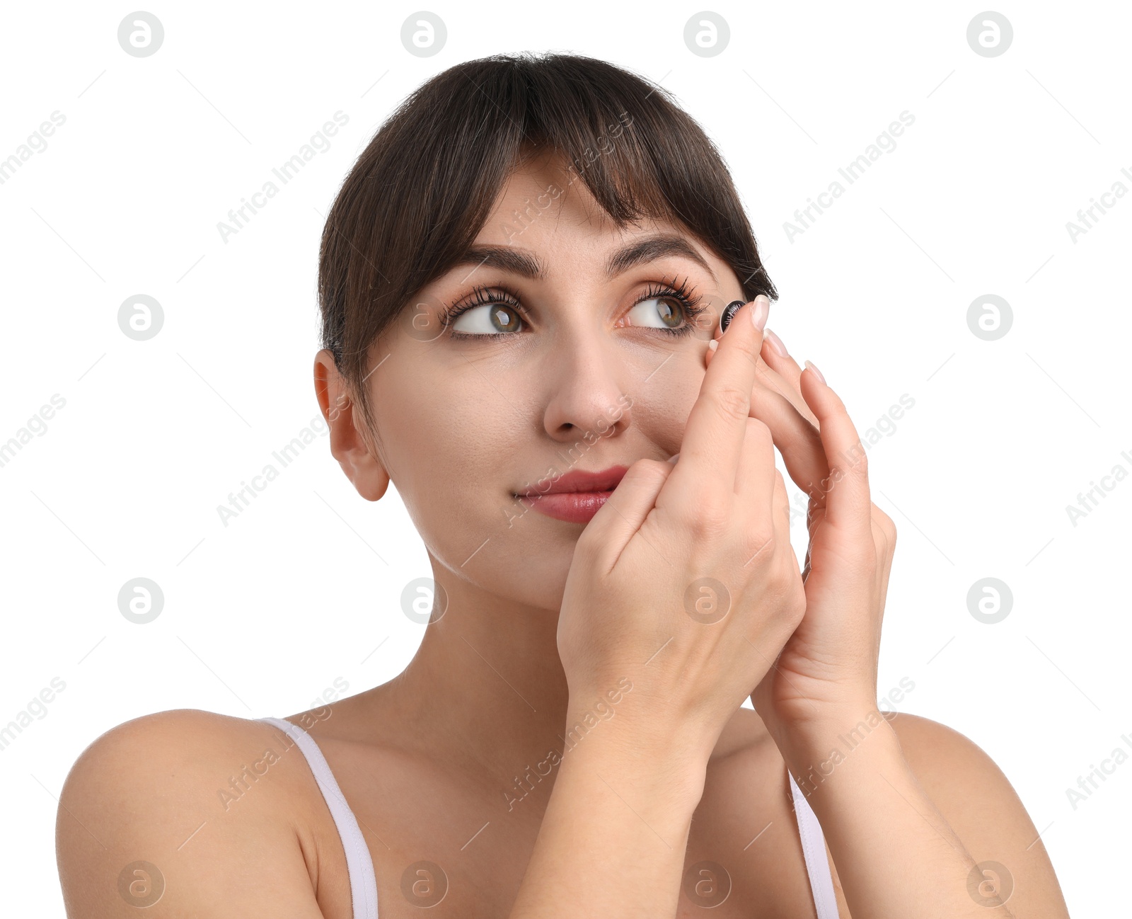 Photo of Young woman putting in color contact lens on white background