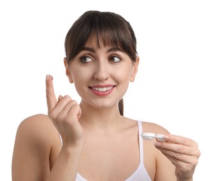 Young woman with color contact lens and case on white background