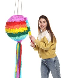 Photo of Happy woman hitting colorful pinata with stick on white background