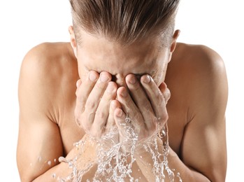 Photo of Man washing his face on white background