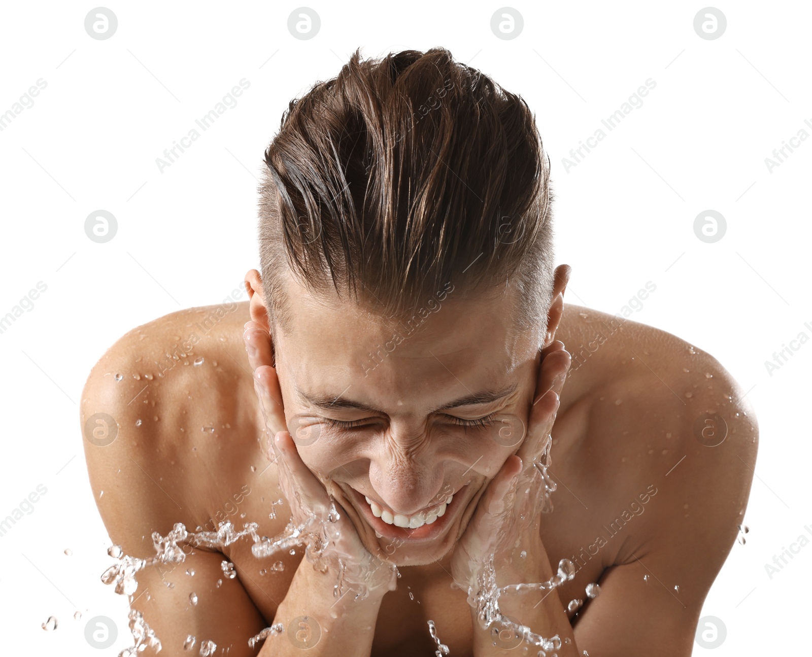 Photo of Smiling man washing his face on white background