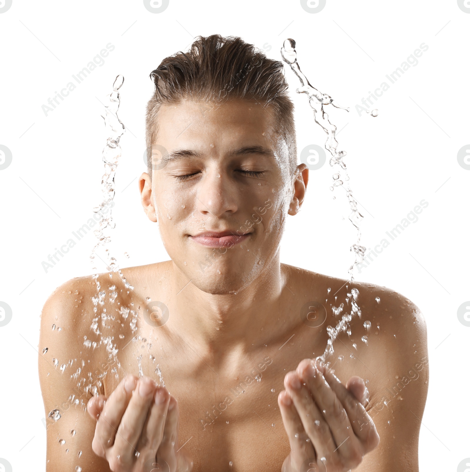 Photo of Handsome man washing his face on white background