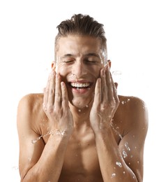 Photo of Smiling man washing his face on white background