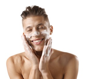 Photo of Smiling man washing his face with cleansing foam on white background