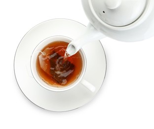 Pouring hot water into cup with tea bag on white background, top view