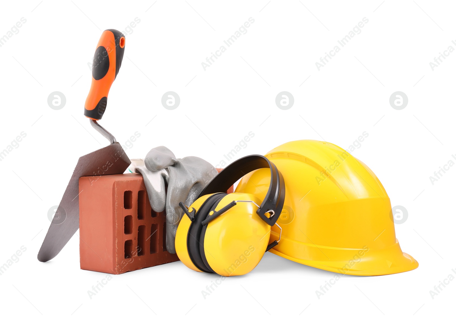 Photo of Protective equipment, brick and construction tool isolated on white