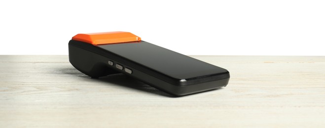 Photo of Payment terminal on wooden table against white background