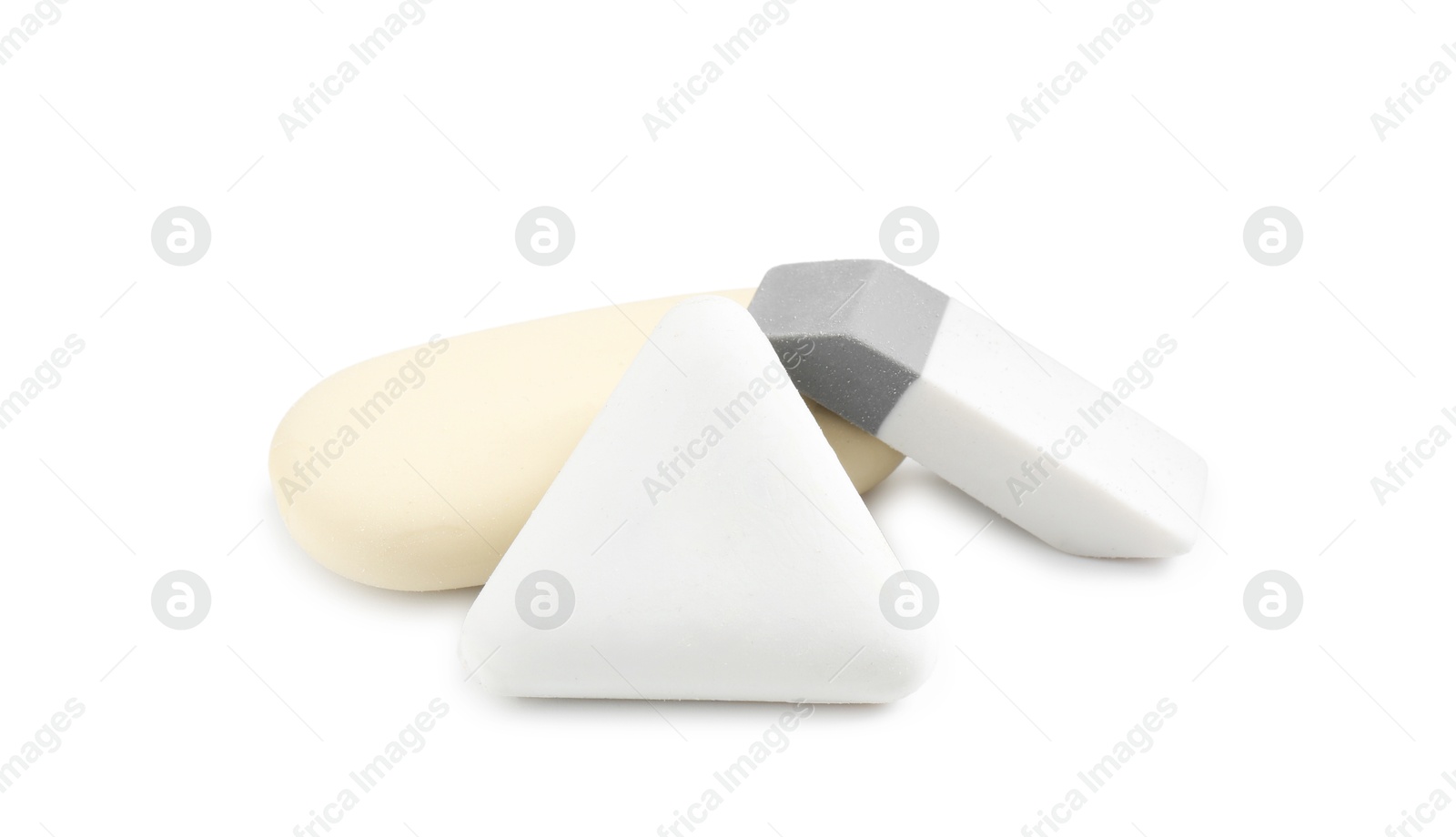 Photo of Different new erasers isolated on white. School stationery