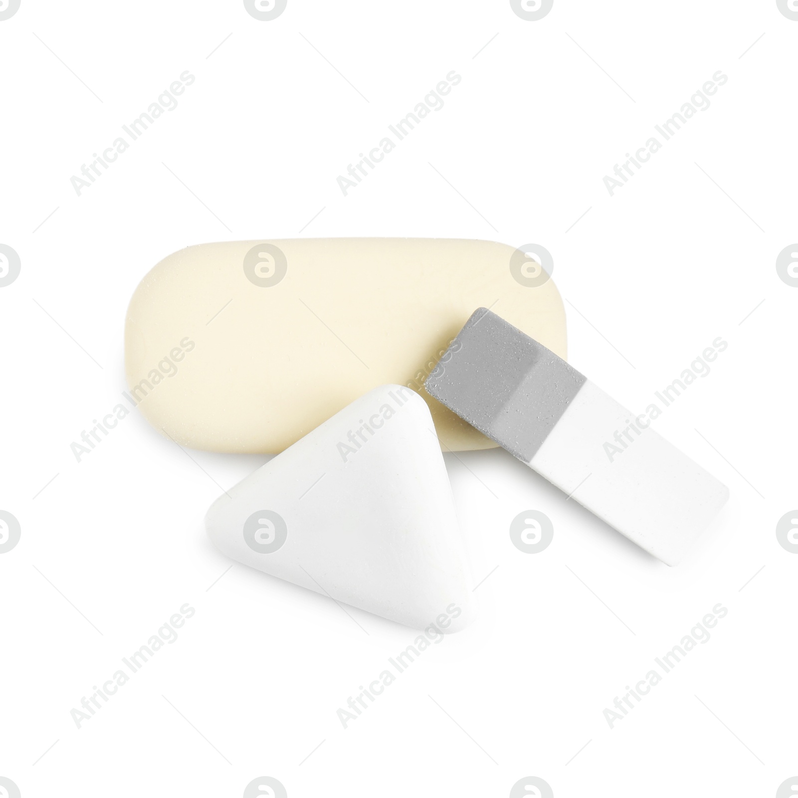 Photo of Different new erasers isolated on white, top view. School stationery