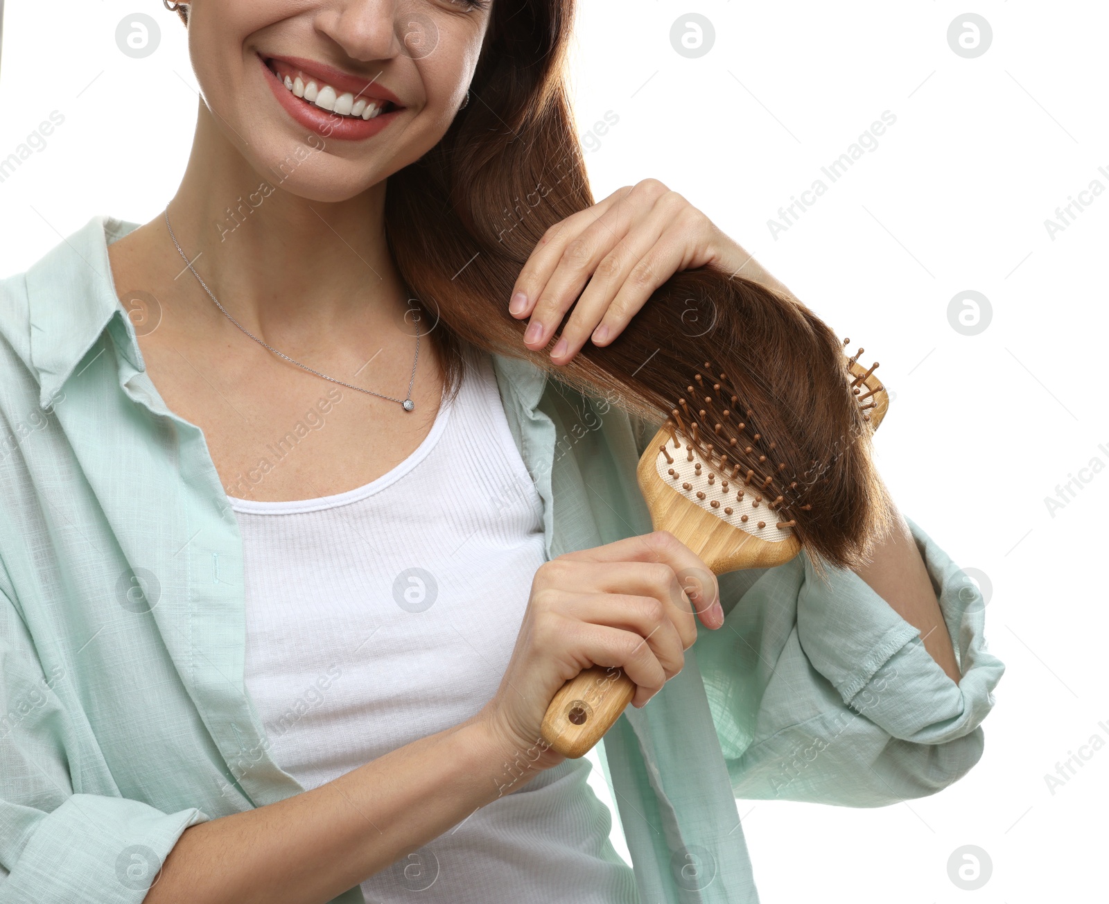 Photo of Woman brushing her hair on white background, closeup