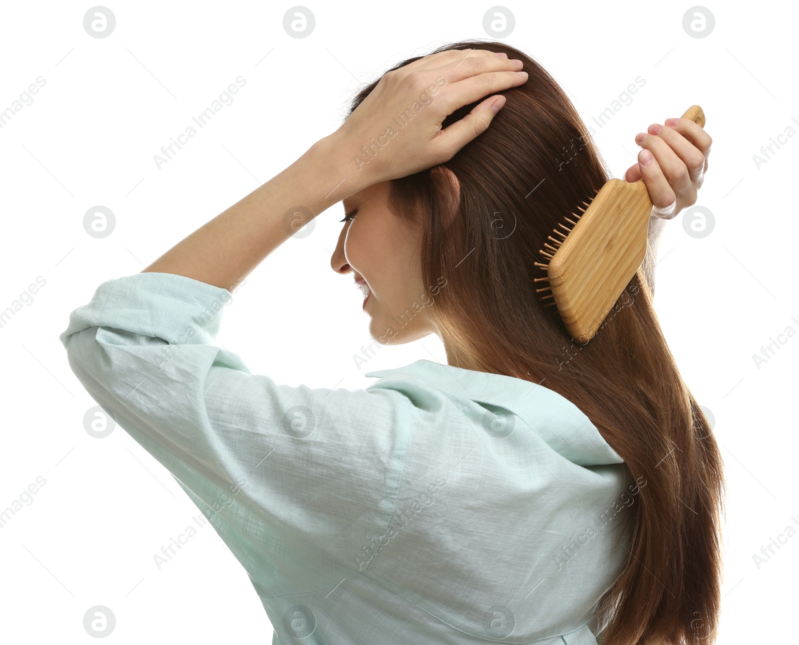 Photo of Woman brushing her hair on white background