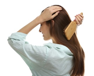 Photo of Woman brushing her hair on white background