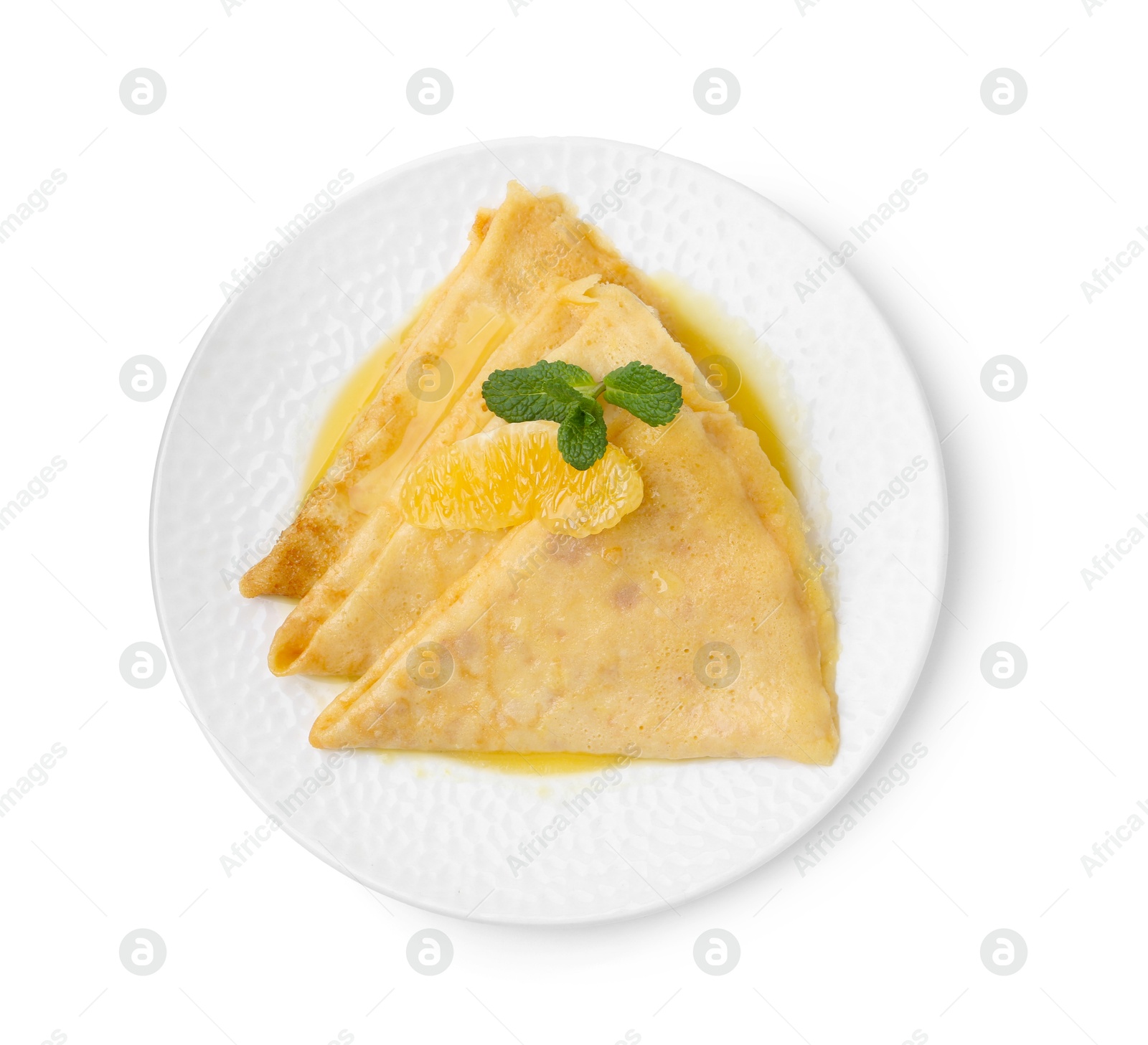 Photo of Plate with tasty crepes Suzette isolated on white, top view