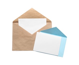 Photo of Envelopes isolated with cards on white, top view. Mockup for design