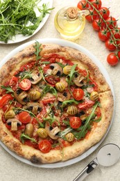 Photo of Tasty pizza with mushrooms, olives, tomatoes and arugula served on white textured table, flat lay