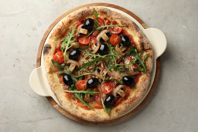 Photo of Tasty pizza with mushrooms, olives and arugula on light grey table, top view