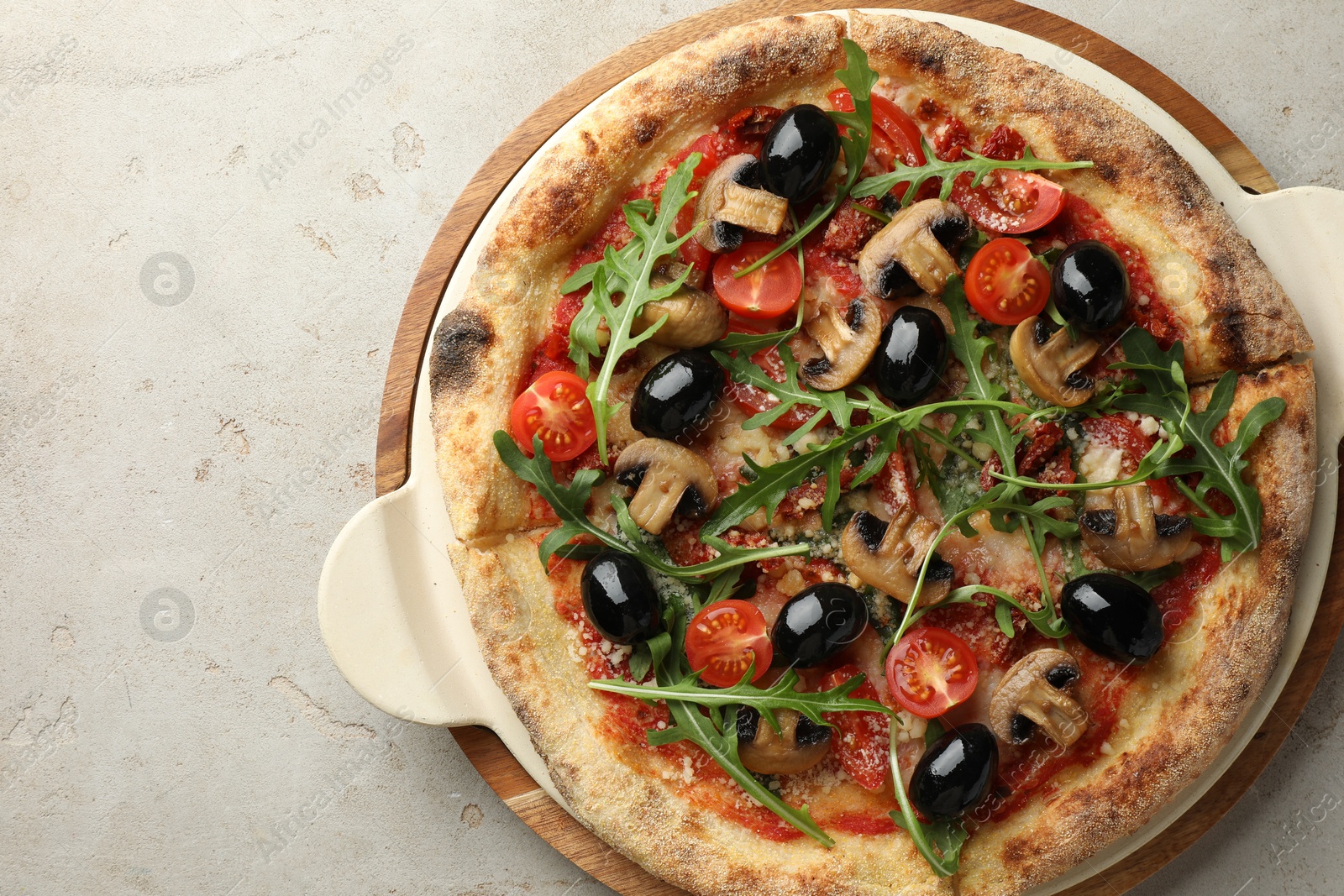 Photo of Tasty pizza with mushrooms, olives and arugula on light grey table, top view. Space for text