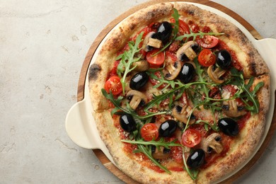 Photo of Tasty pizza with mushrooms, olives and arugula on light grey table, top view. Space for text