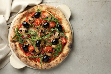 Photo of Tasty pizza with mushrooms, olives and arugula on light grey table, top view. Space for text