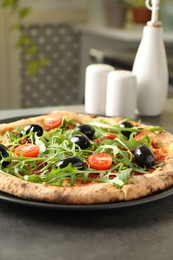 Photo of Delicious pizza with olives, cherry tomatoes and arugula on grey table indoors, closeup