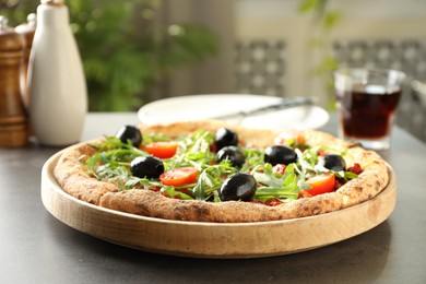 Photo of Delicious pizza with olives, cherry tomatoes and arugula on grey table indoors, closeup