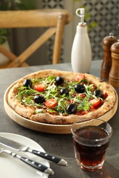 Photo of Delicious pizza with olives, cherry tomatoes, arugula and soda drink on grey table indoors, closeup