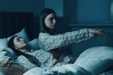 Image of Young woman suffering from sleepwalking at home, double exposure. Toned in blue