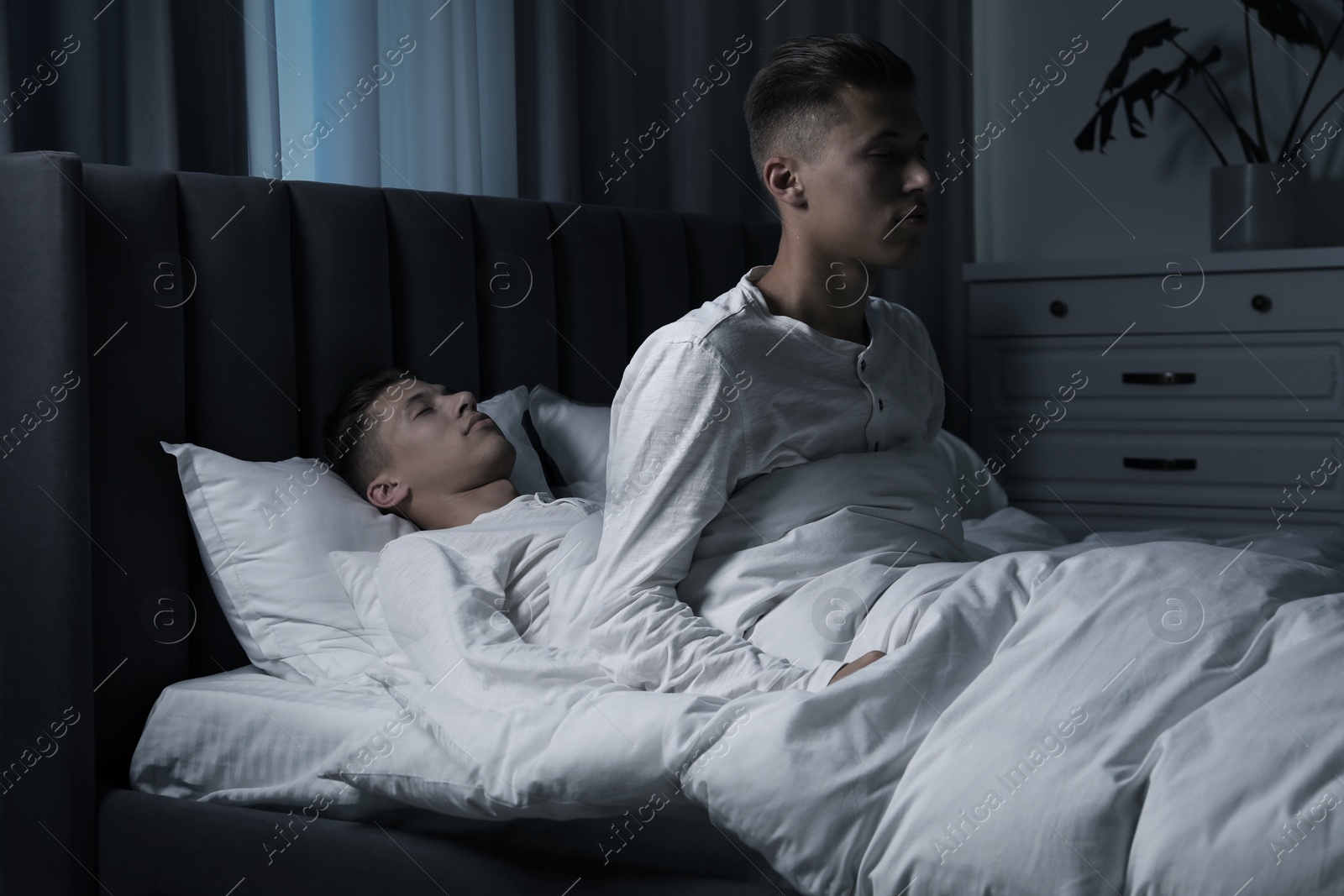 Image of Young man suffering from sleepwalking at home, double exposure