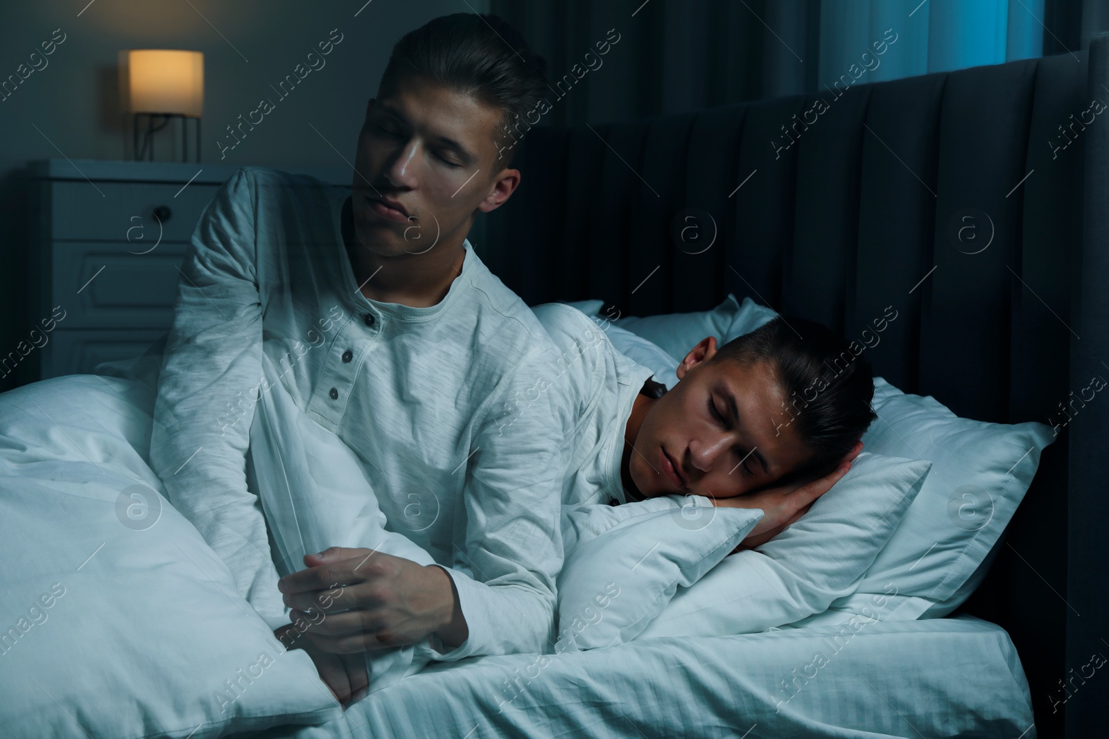 Image of Young man suffering from sleepwalking at home, double exposure