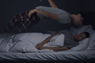 Young man suffering from sleepwalking at home, double exposure