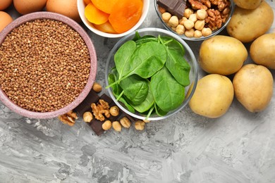 Photo of Different products rich in iron on grey table, flat lay. Diet plan for anemia