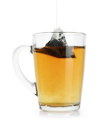 Photo of Putting tea bag into glass cup on white background