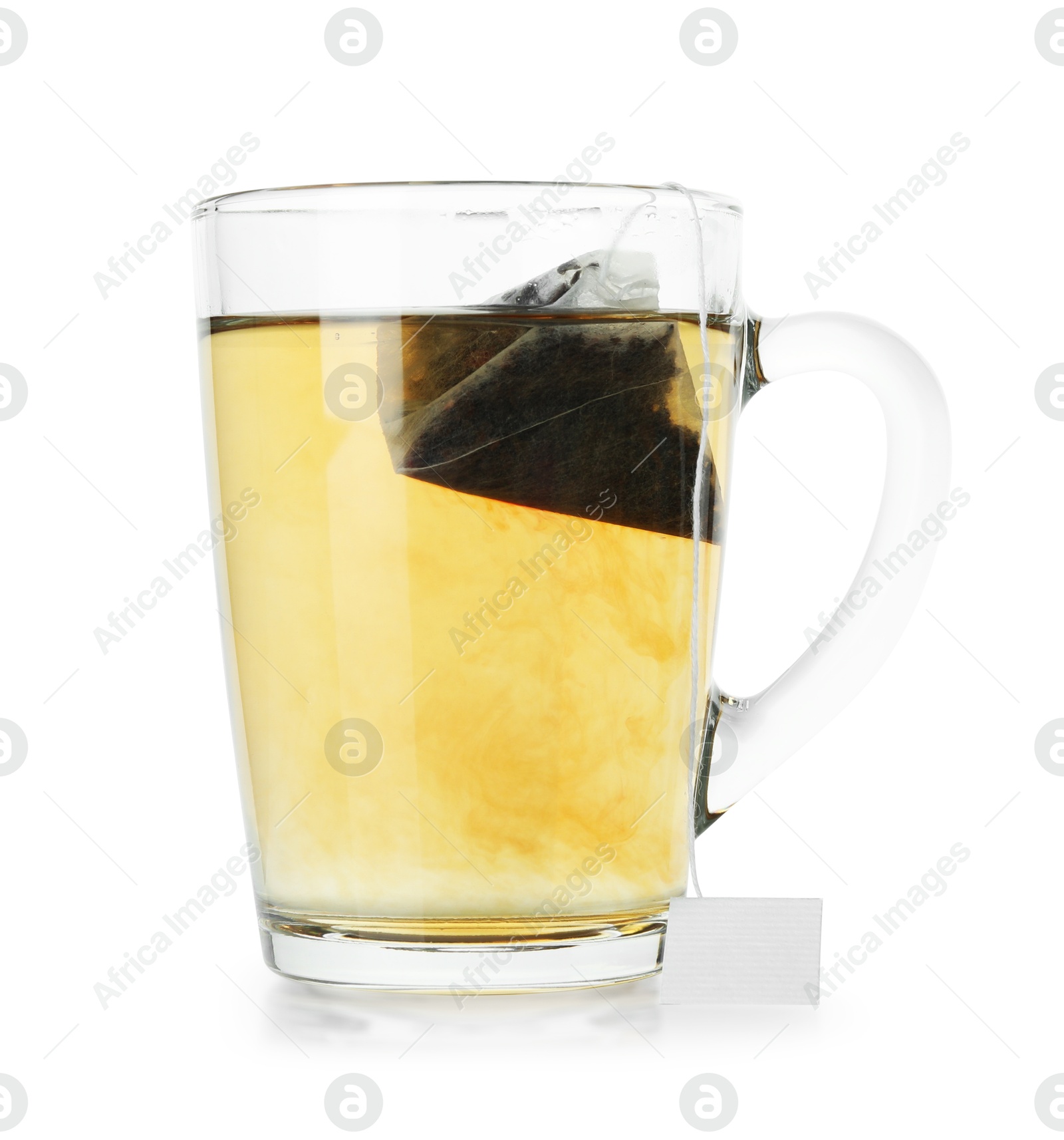 Photo of Tea bag in glass cup with hot drink isolated on white