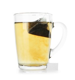 Photo of Tea bag in glass cup with hot drink isolated on white