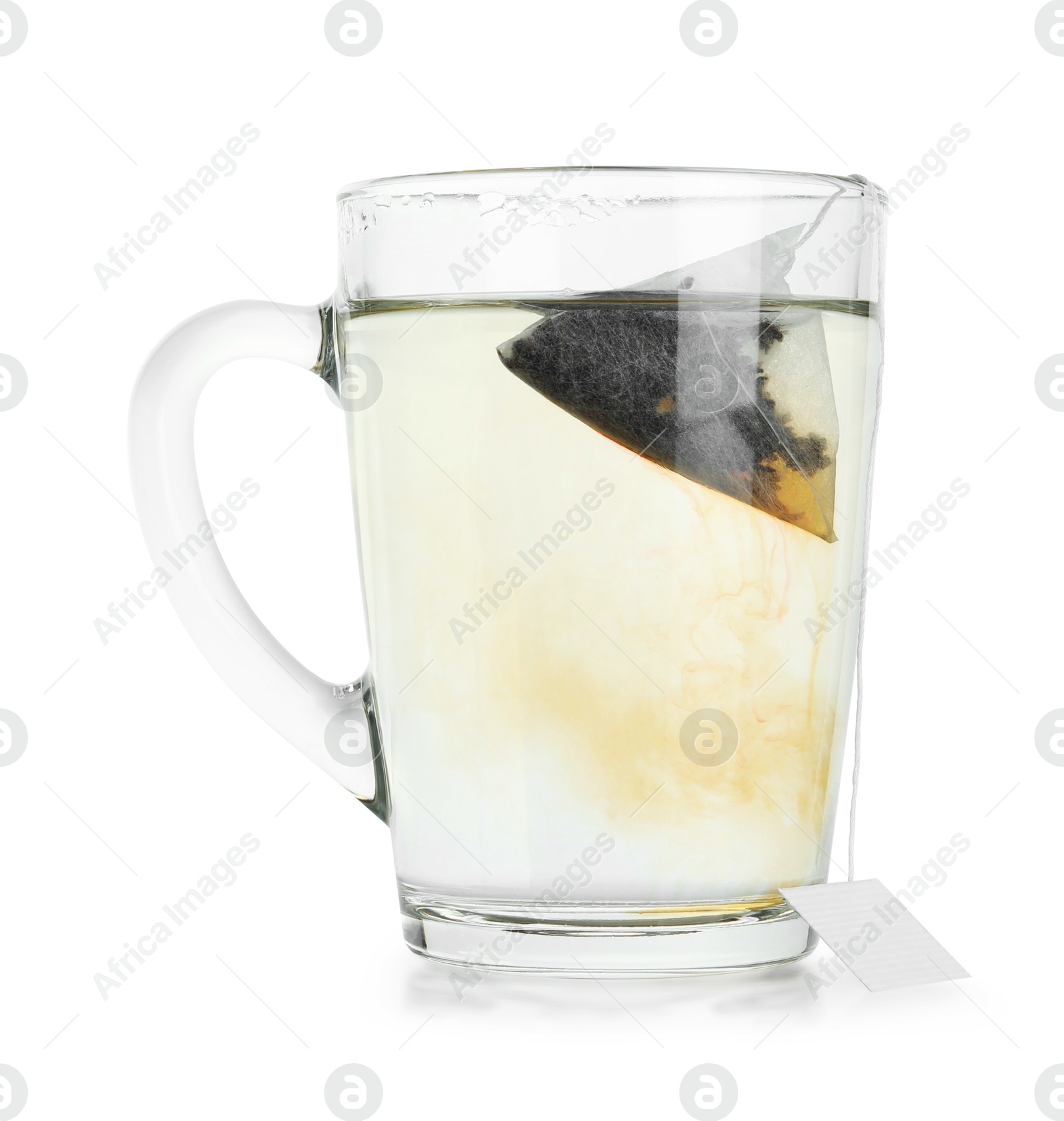 Photo of Tea bag in glass cup with hot drink isolated on white