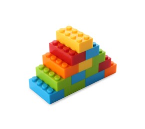 Photo of Construction toy. Pyramid made with building bricks isolated on white