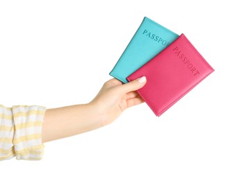 Photo of Woman holding passports in color covers on white background, closeup