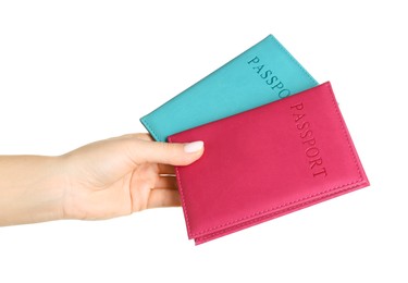 Photo of Woman holding passports in color covers on white background, closeup