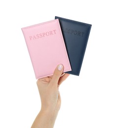 Photo of Woman holding passports in color covers on white background, closeup