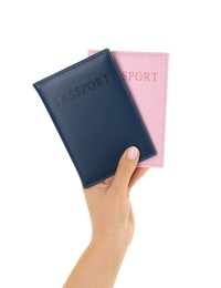 Photo of Woman holding passports in color covers on white background, closeup