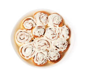 Photo of Delicious frosted cinnamon rolls in baking dish isolated on white, top view