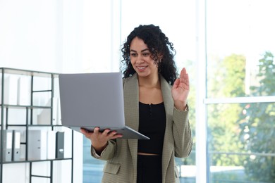 Photo of Portrait of young woman with laptop wearing stylish suit indoors